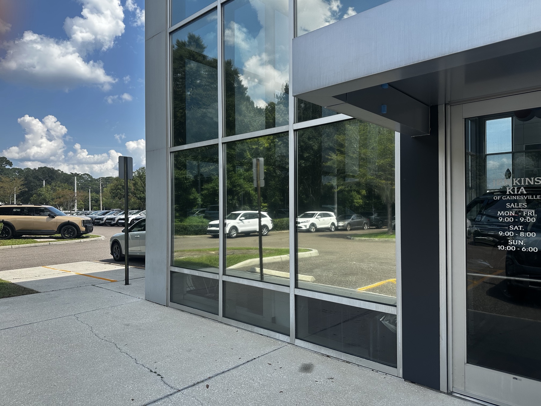 Tinted showroom windows reflecting the sky