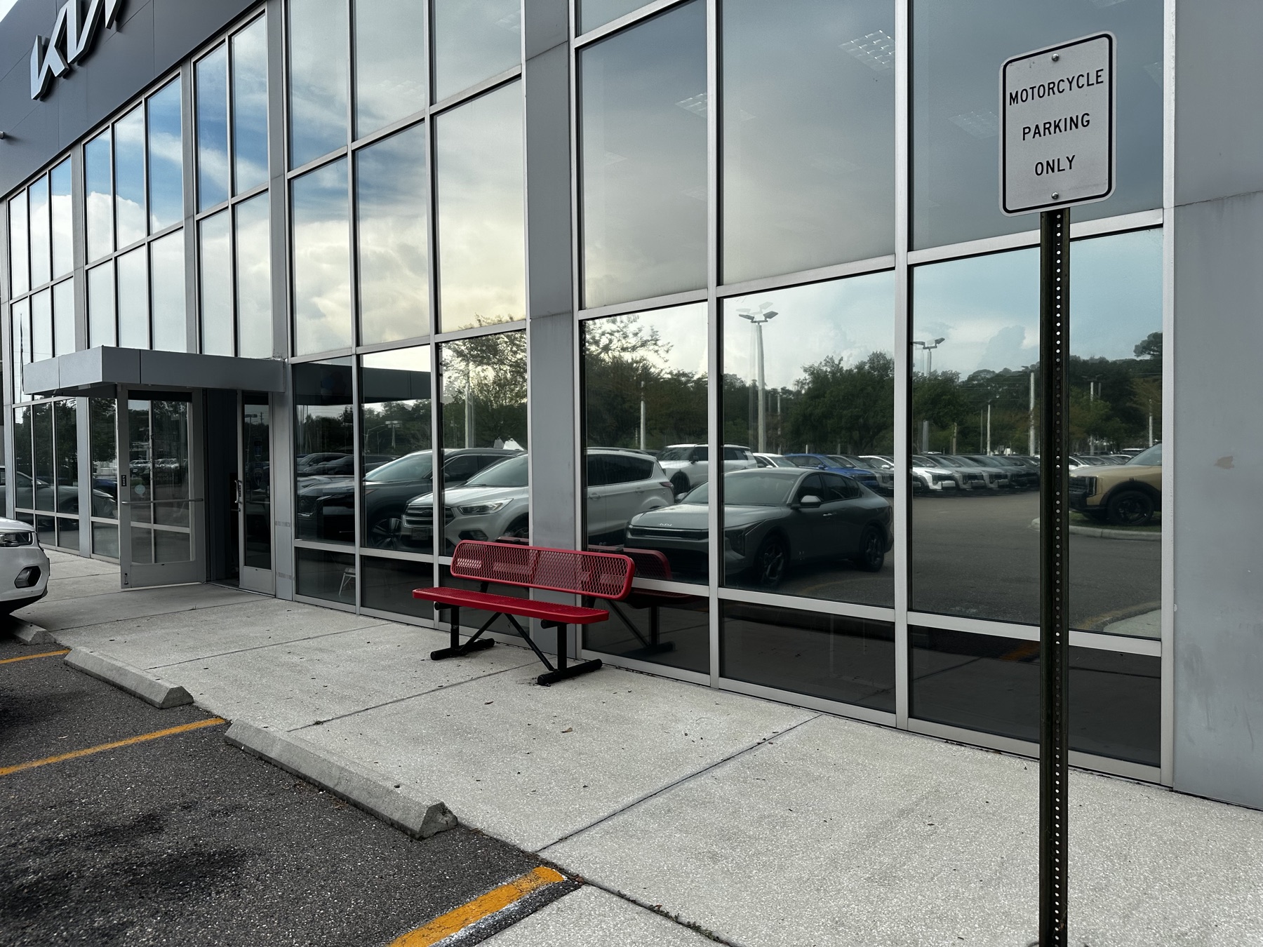 Tinted exterior glass with a red bench in front